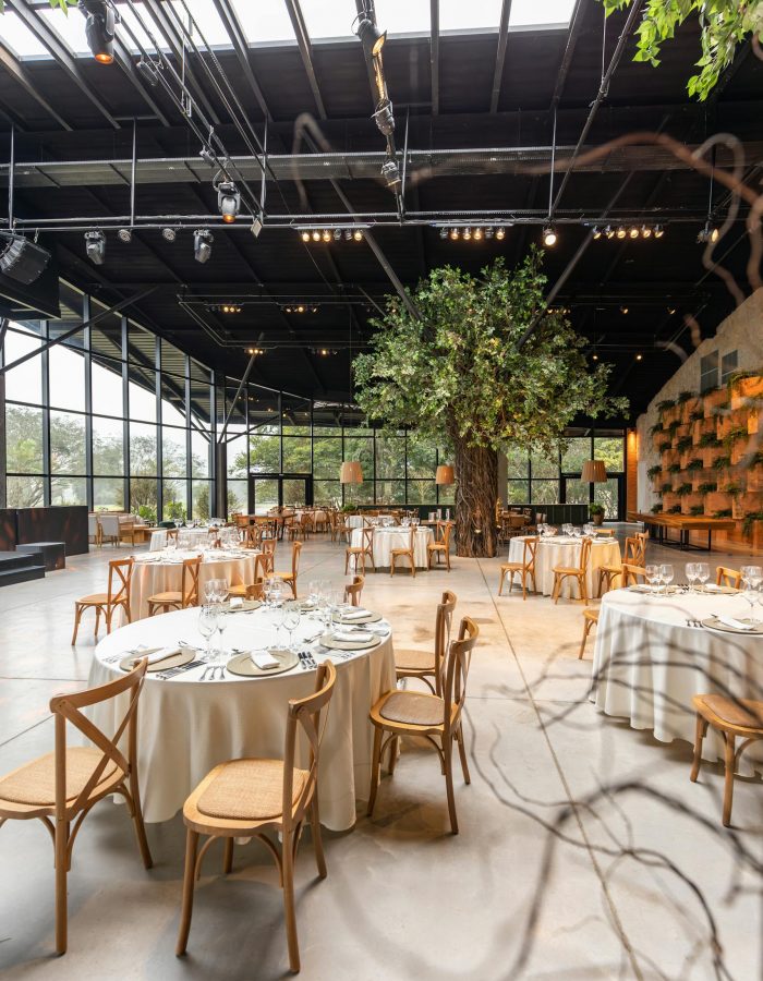 a-luxurious-banquet-hall-with-rustic-tables-and-a-central-indoor-tree-ideal-for-events.-17056989-scaled